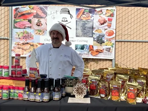 Chef Gregory in front of gourmet product line